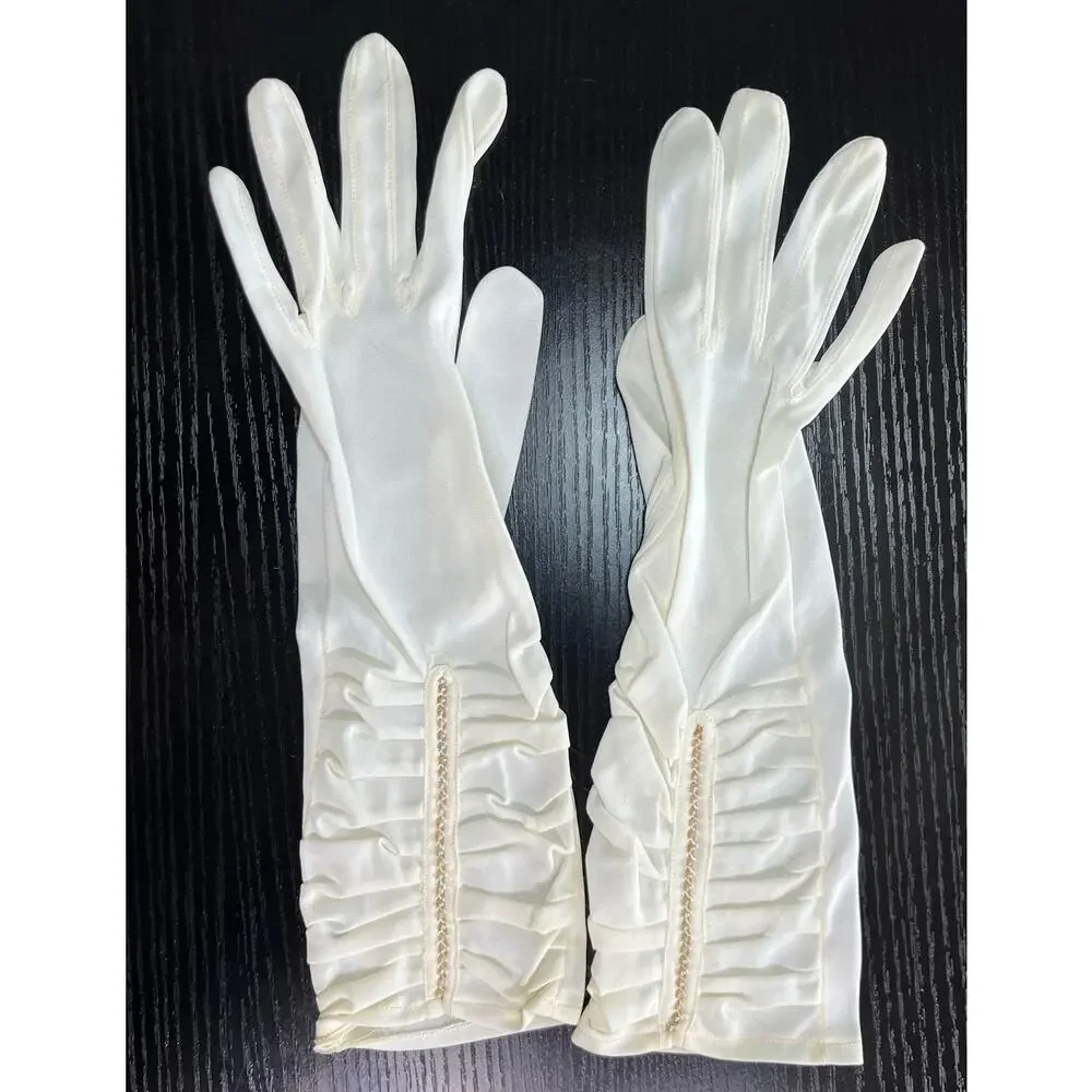 Vintage 60's era elegant long dress gloves tagged with faux pearl accents